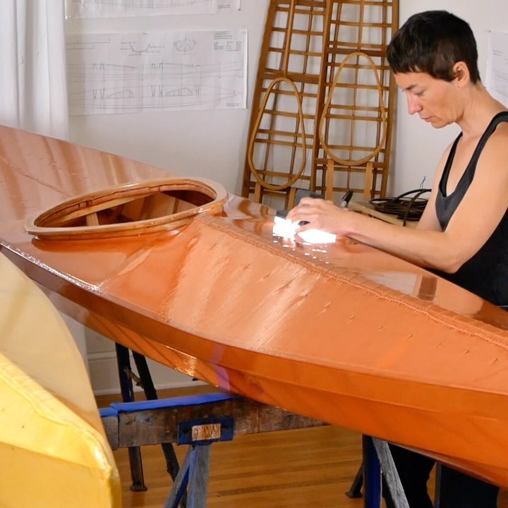 Woman working on a kayak deck