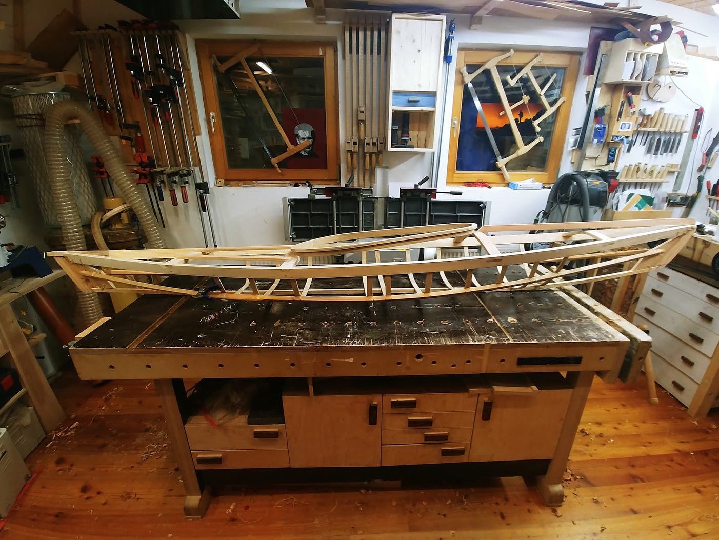 a small skin on frame kayak frame being built in a workshop
