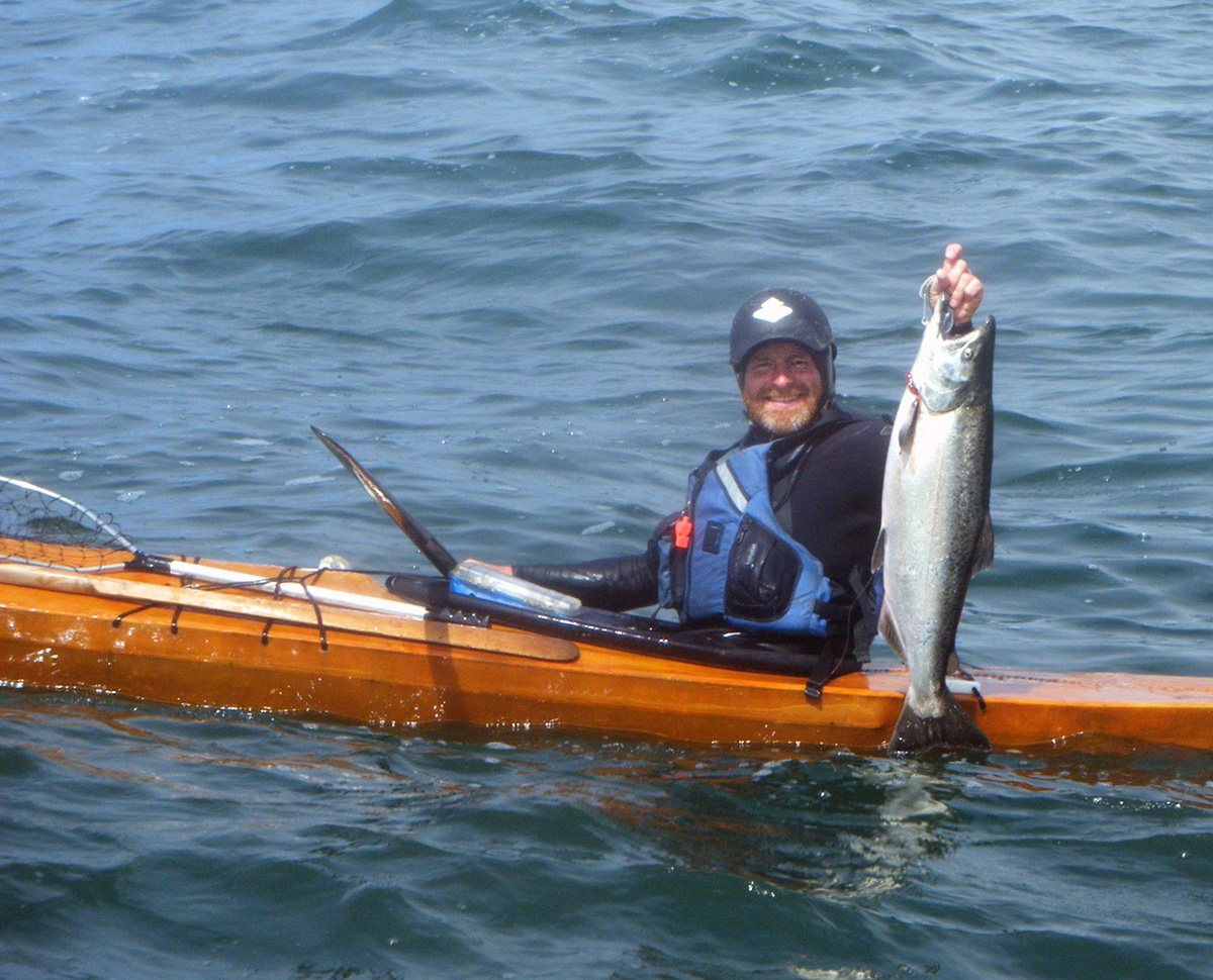 man salmon fishing out of a skin on frame F1 kayak