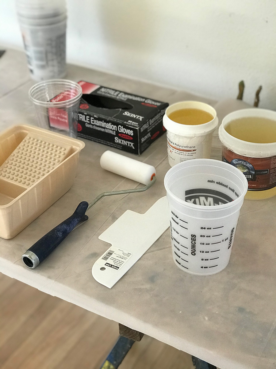 polyurethane kayak coating supplies laid out on table